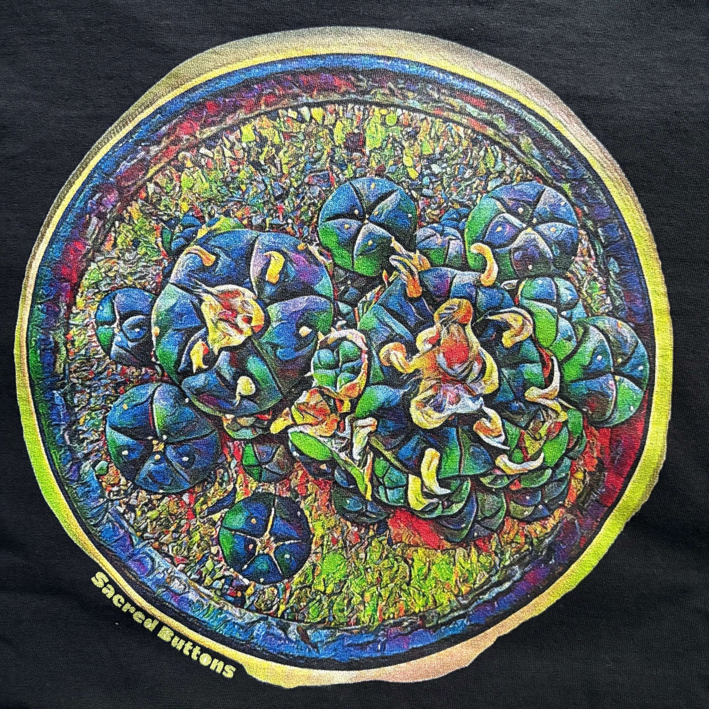A close up of the custom Sacred Buttons artwork on a t-shirt.