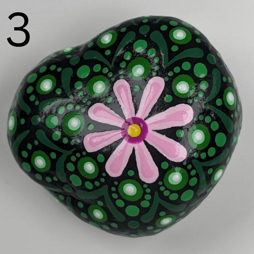A stone for your garden that is painted to look like a peyote cactus.