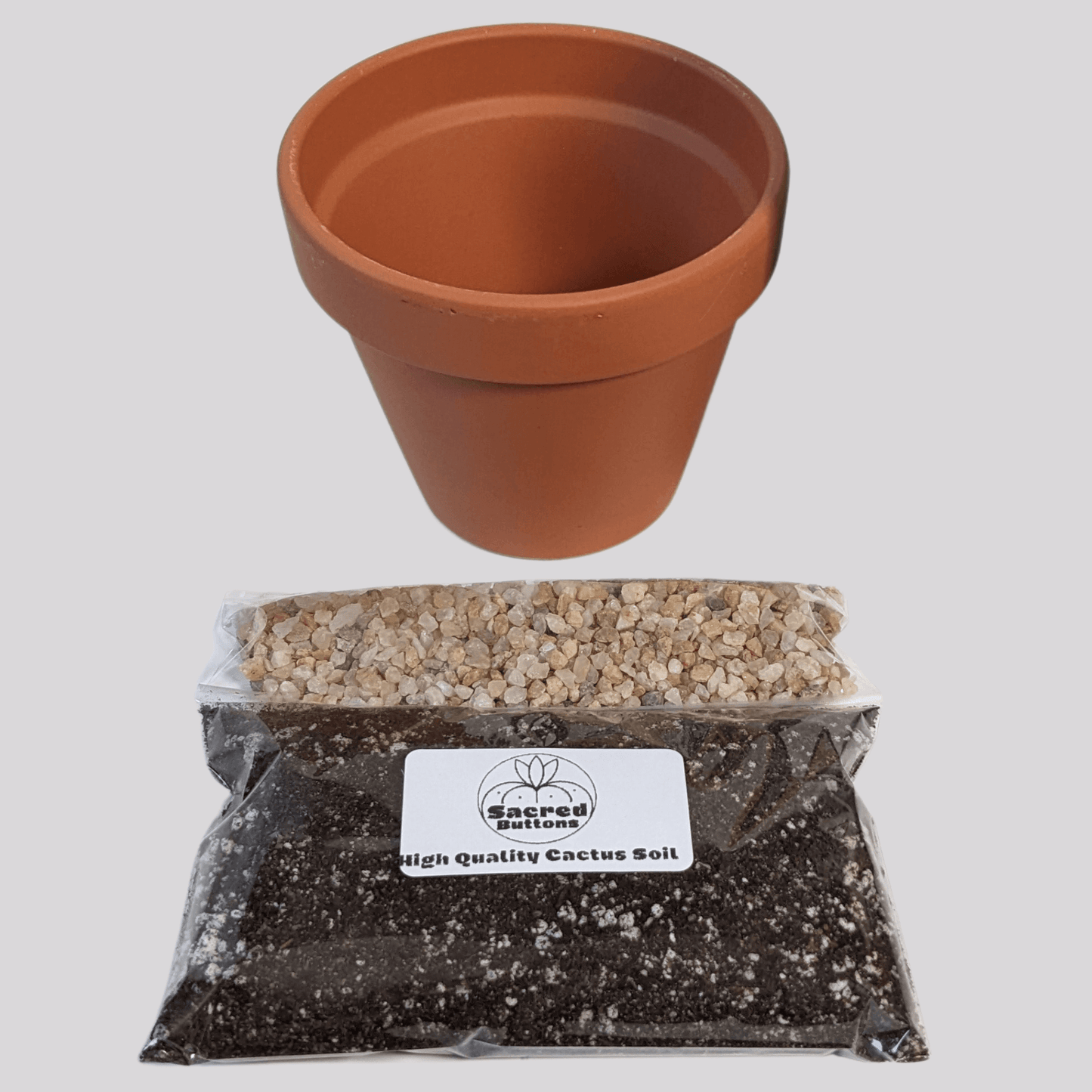 A cactus potting kit that includes a clay pot, a bag of soil, and soil topping stones.